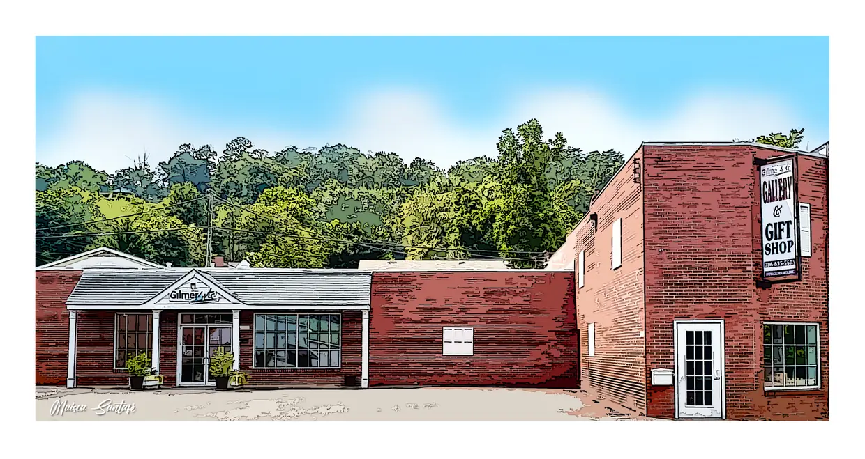 A red-brick arts-center building at a corner: a one-story glass-fronted storefront porch on the left, a long brick wall in the middle and a taller two-story brick block on the right.